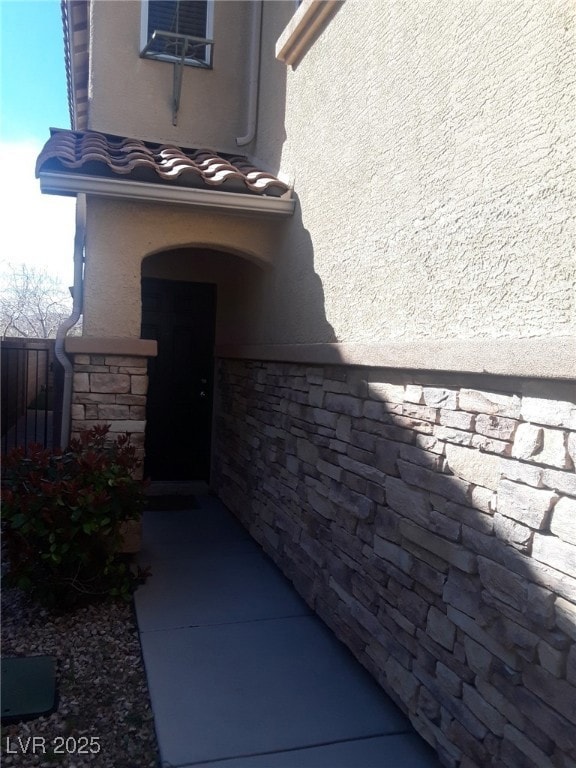Doorway to property with stone siding