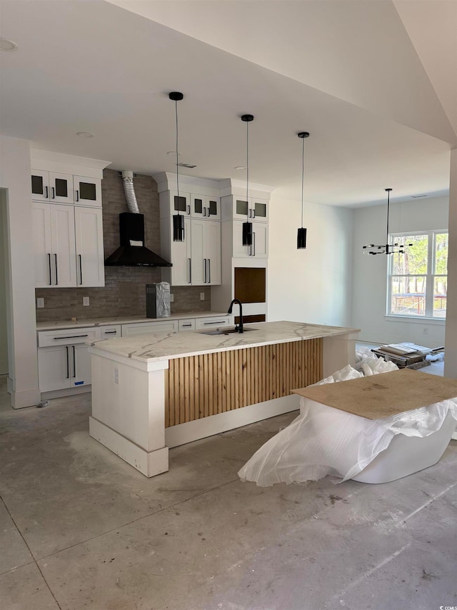 Kitchen with pendant lighting, a spacious island, 