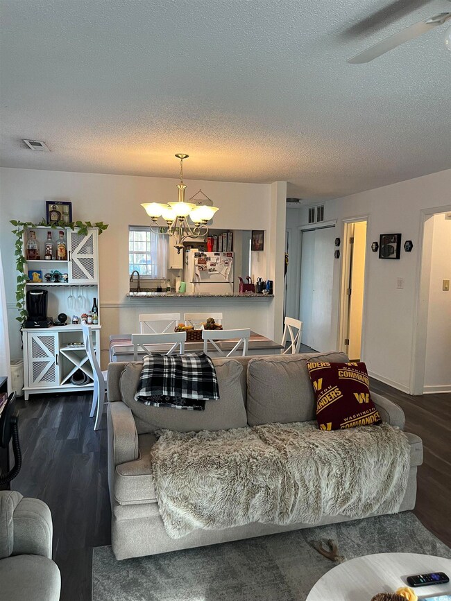Living room featuring ceiling fan with notable cha