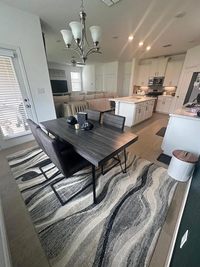 Dining room with visible vents and an inviting ch