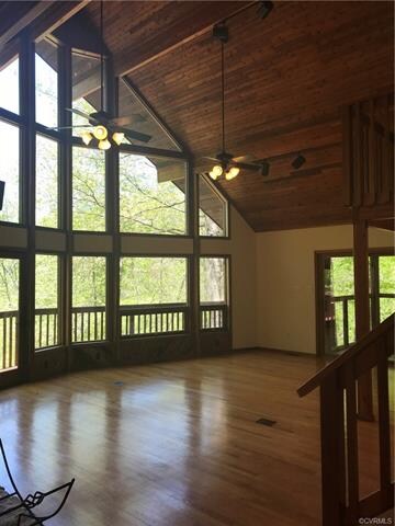 As soon as you walk into the great room you will be drawn to the beautiful custom wood beams, wood ceilings, stone fireplace and amazing water views.  These views are far and few in between!  Its like looking into natures paradise all year round.