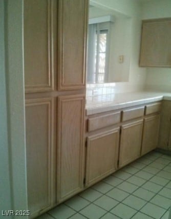 Kitchen with light tile patterned floors