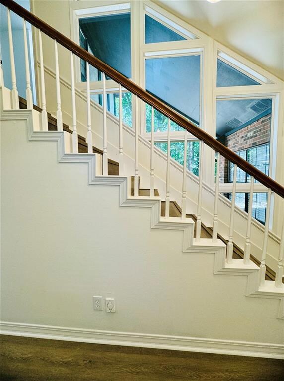 Staircase with a wealth of natural light and dark 