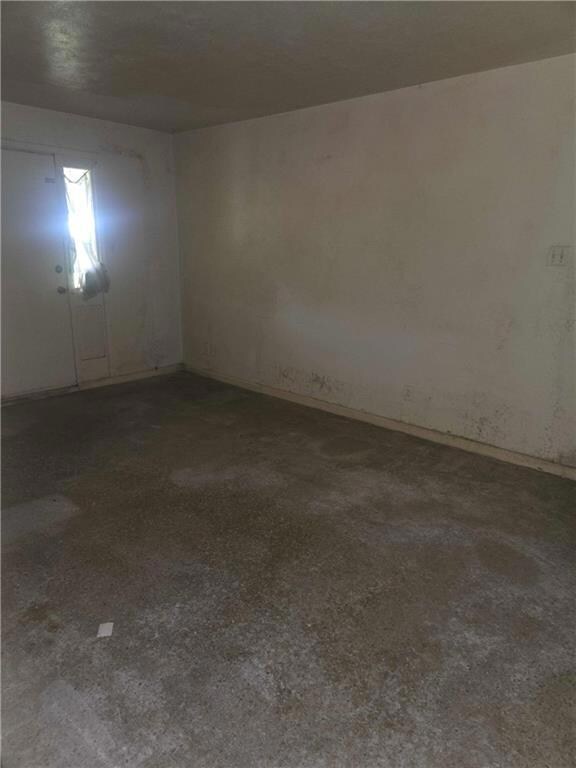 Unfurnished room featuring baseboards