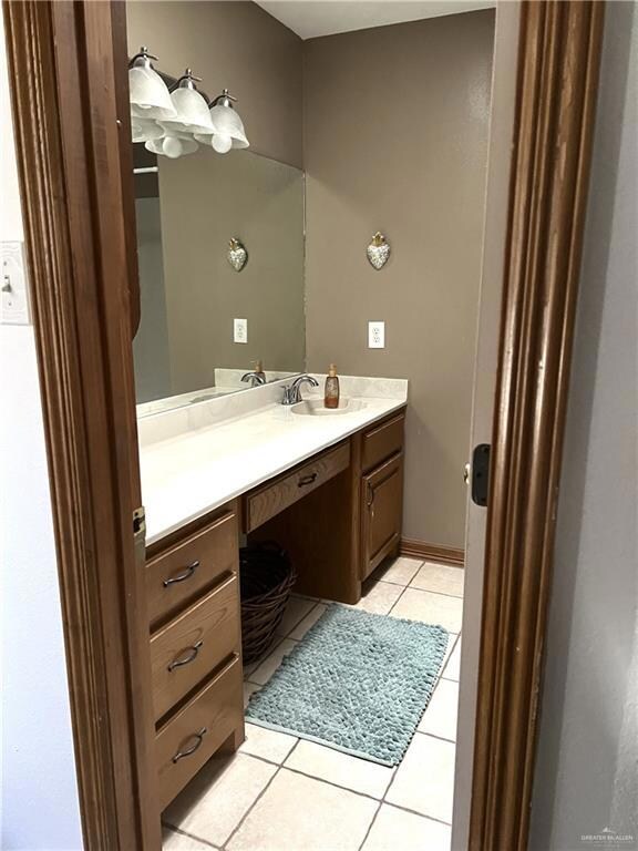 Bathroom with tile patterned flooring and vanity