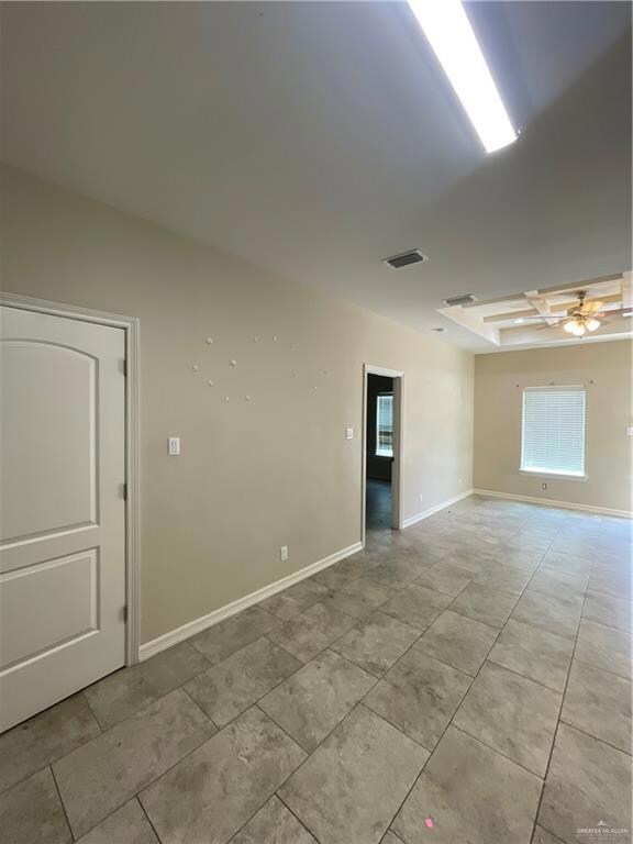 Tiled spare room with ceiling fan