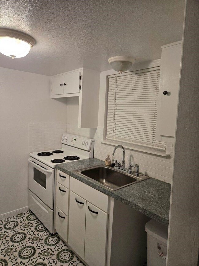 This compact kitchen features a classic white desi