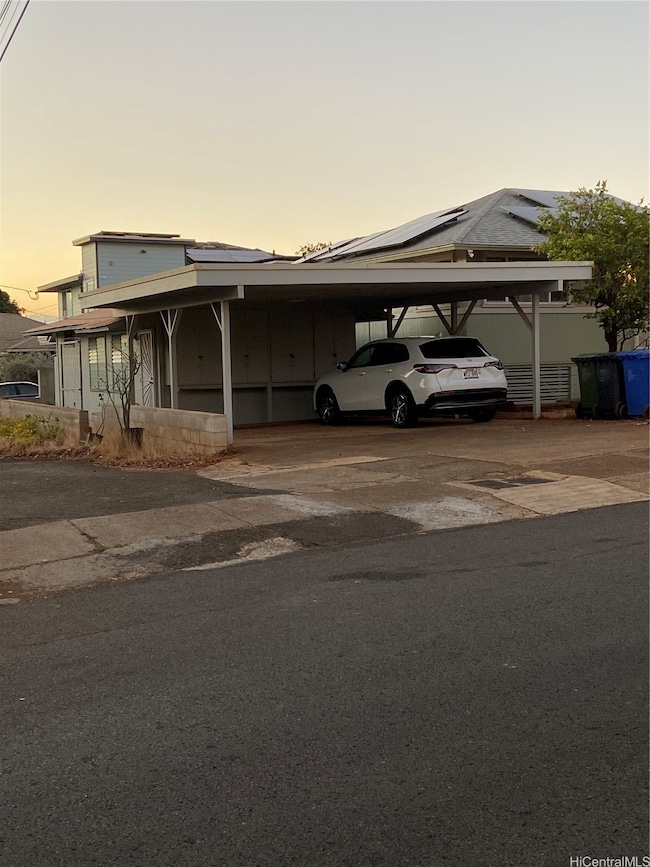 Studio on the left side and behind carport.