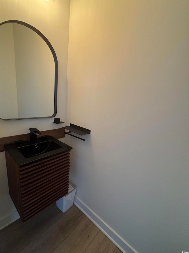 Detailed view of wood finished floors and vanity