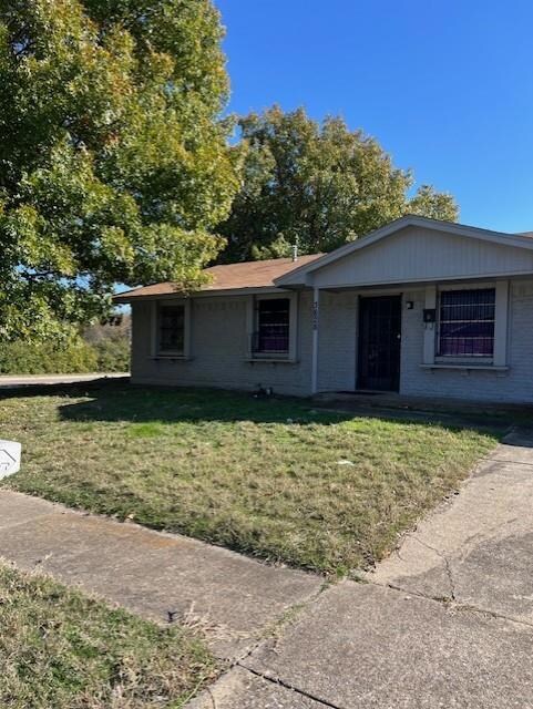 View of front of house featuring brick siding and 