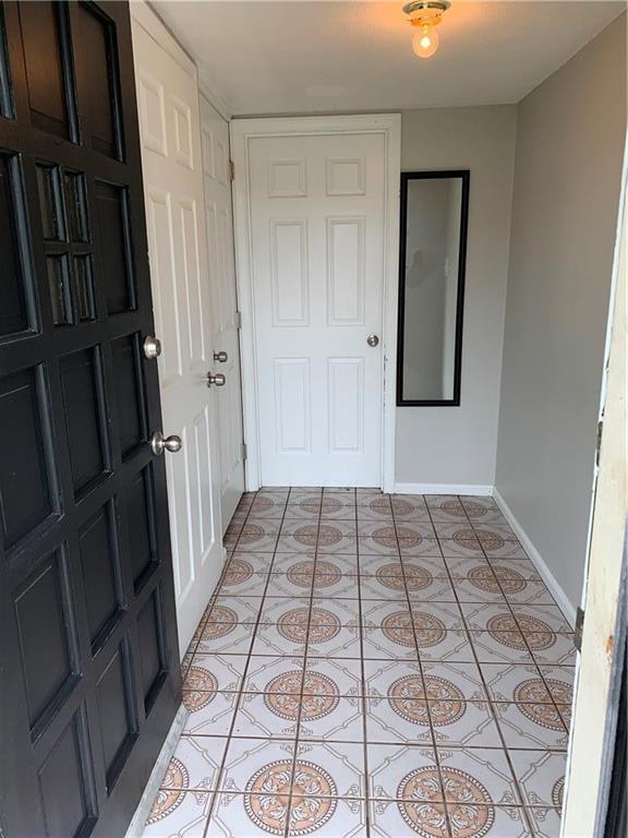 ENTRYWAY TO HOME WITH BEAUTIFUL CERAMIC TILE FLOOR