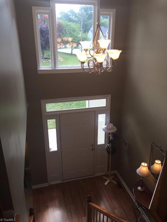 Lovely two story foyer with wood flooring, transom, windows, and sidelights.