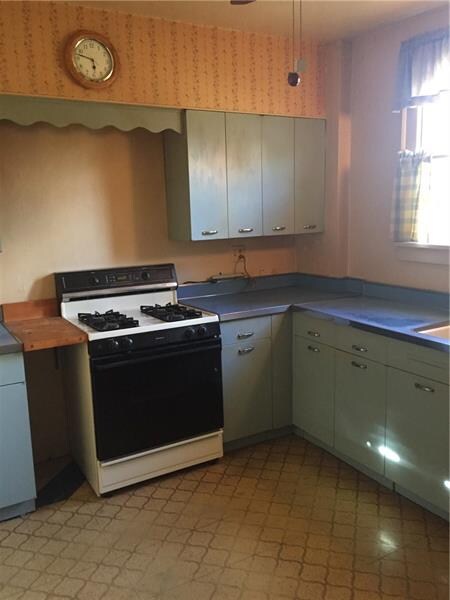 Large kitchen with original metal cabinets.