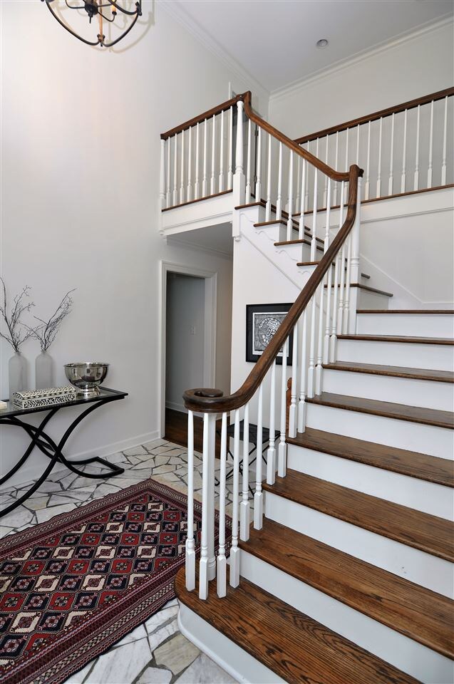 Wrap around staircase leads upstairs to 3 bedrooms