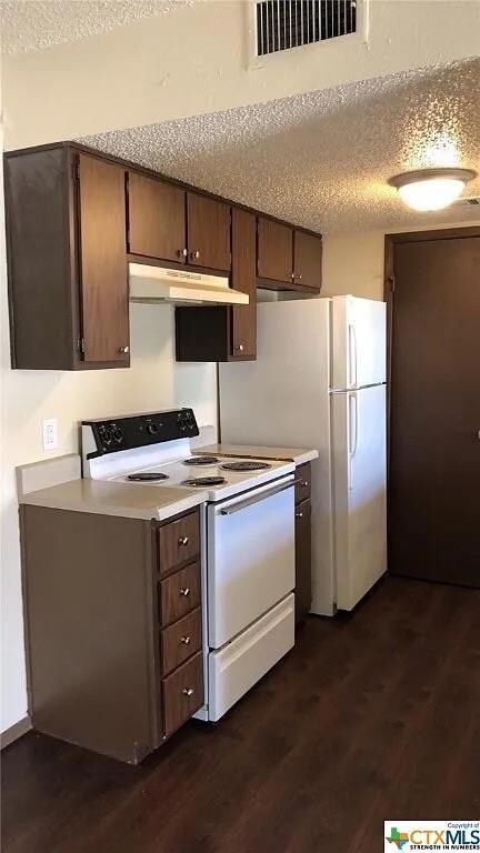 Kitchen with white range with electric cooktop, u