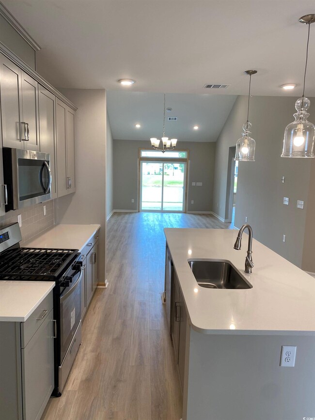 Kitchen featuring sink, light wood-type flooring, 