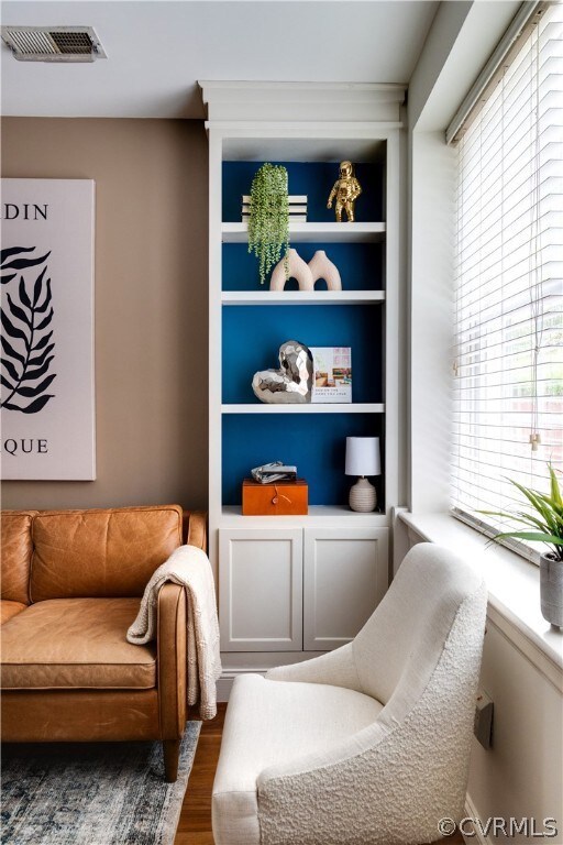 Sitting room with plenty of natural light, hardwoo