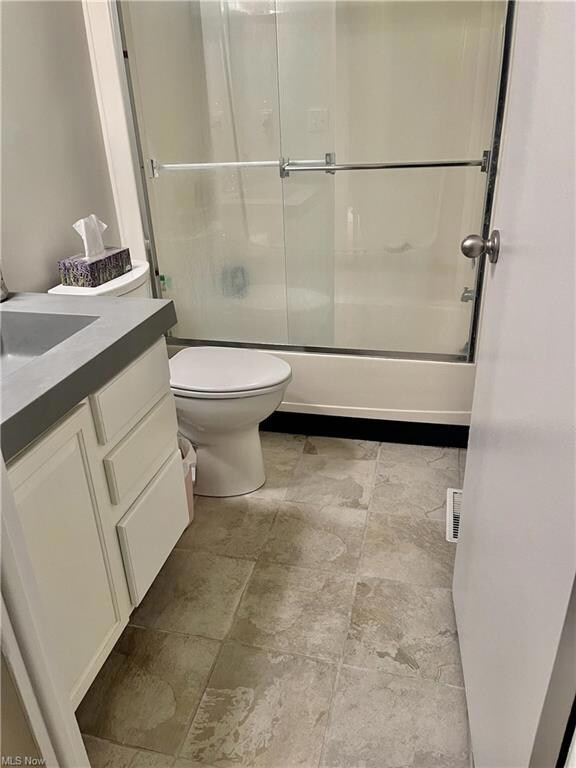Full bathroom with combined bath / shower with gla
