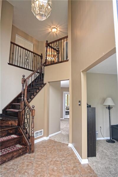 The two story foyers boasts natural sunlight, wrou