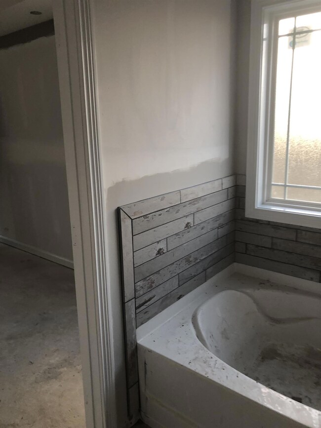 Rustic tile around a tub just makes it a little cozier!