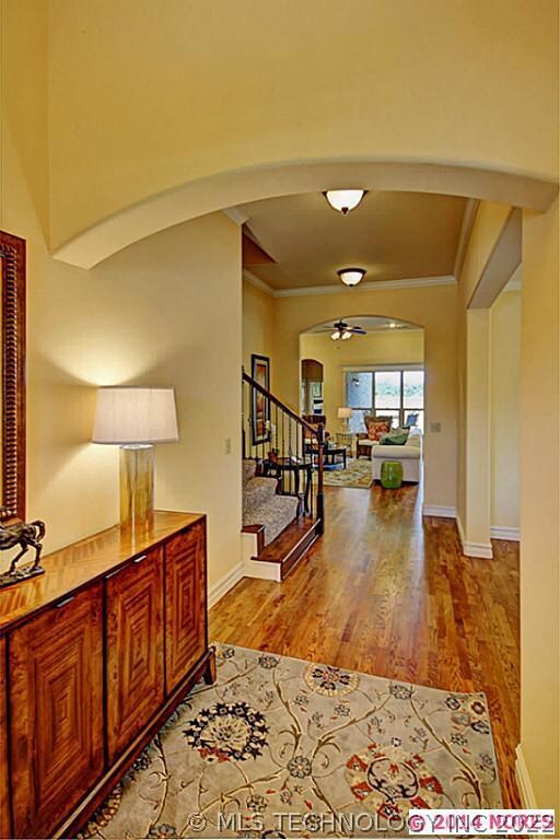 Entry accents include hardwoods and crown molding.