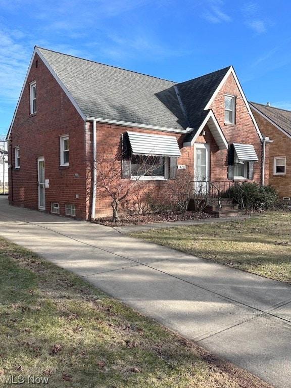 View of property exterior with a lawn