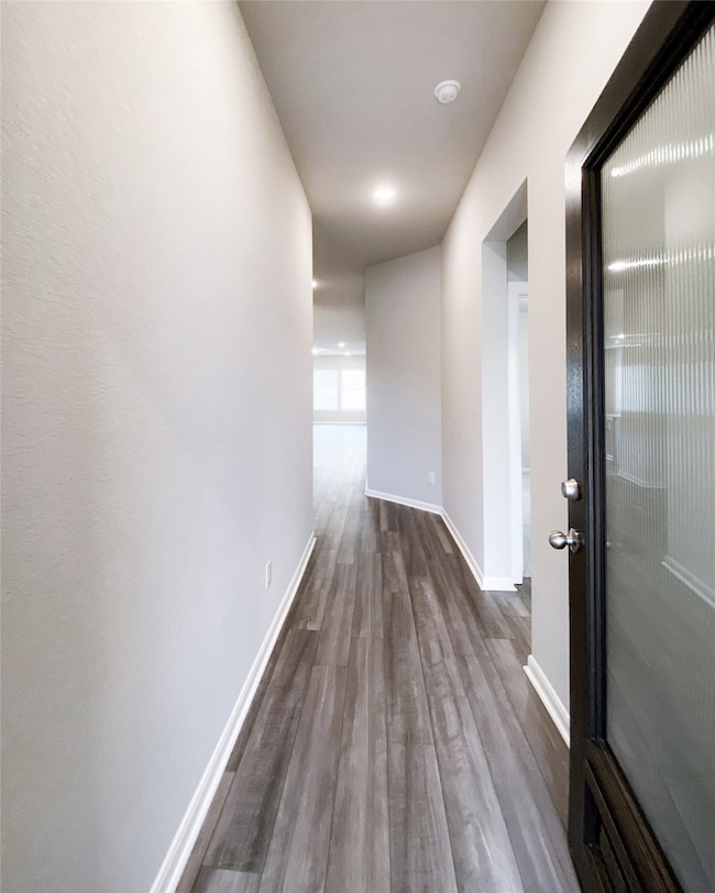 Formal entry with custom door and wood flooring