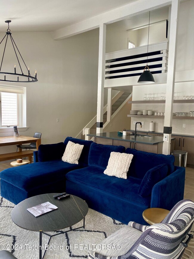 Main living looking to kitchen and loft