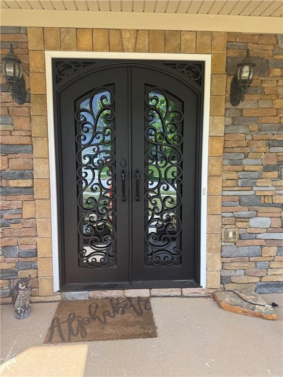 Doorway to property with french doors and brick siding