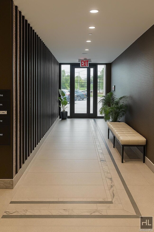 Lobby featuring floor to ceiling windows and recessed lighting