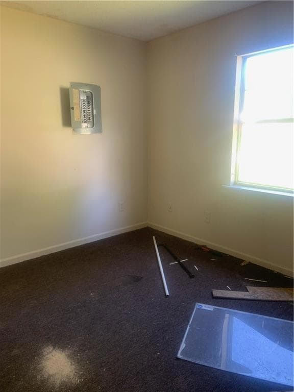 Spare room featuring baseboards