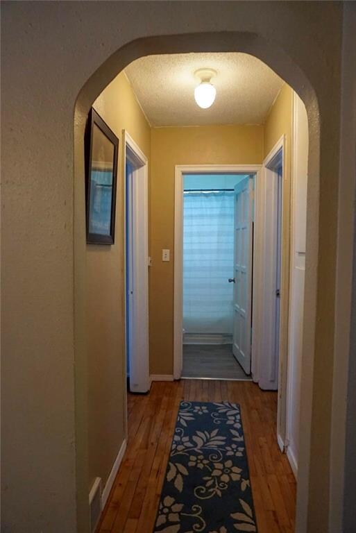 Archways lead you down the hall to the bedrooms an