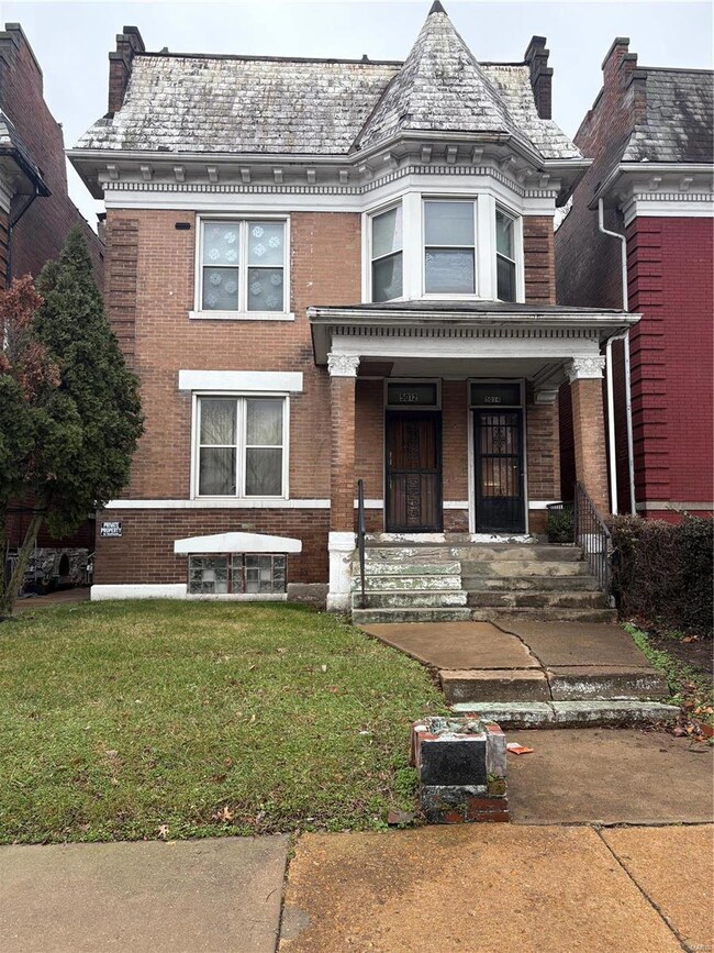 View of front of house with a porch and a front lawn