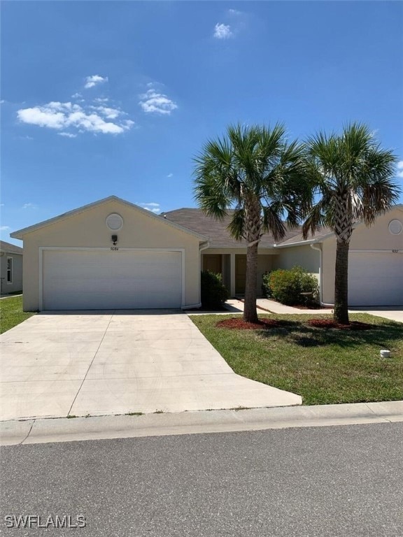 Single story home featuring concrete driveway, an