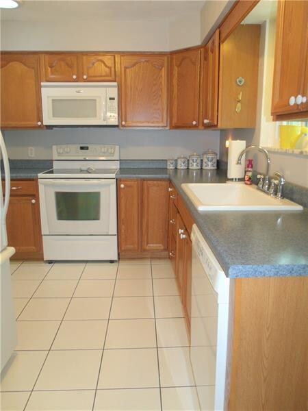 The kitchen has a large sink and an abundance of c