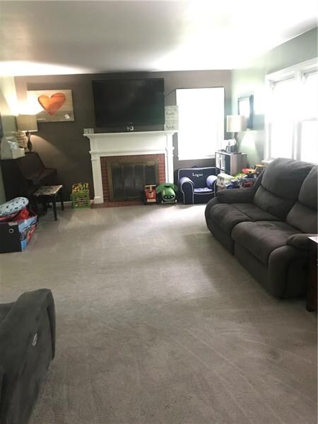 The fireplace centers the living room and new carp