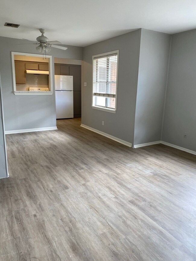 Bright, open living area with light wood flooring,