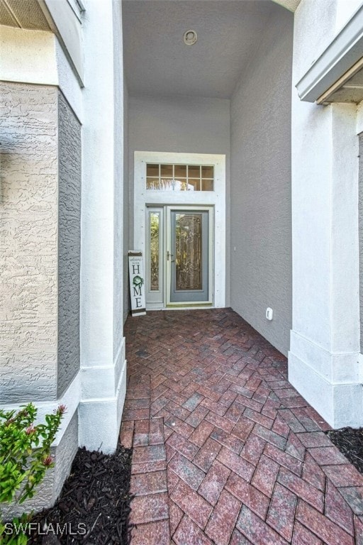 Doorway to property with stucco siding