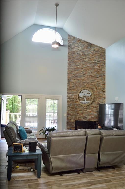Living area with a fireplace, high vaulted ceiling