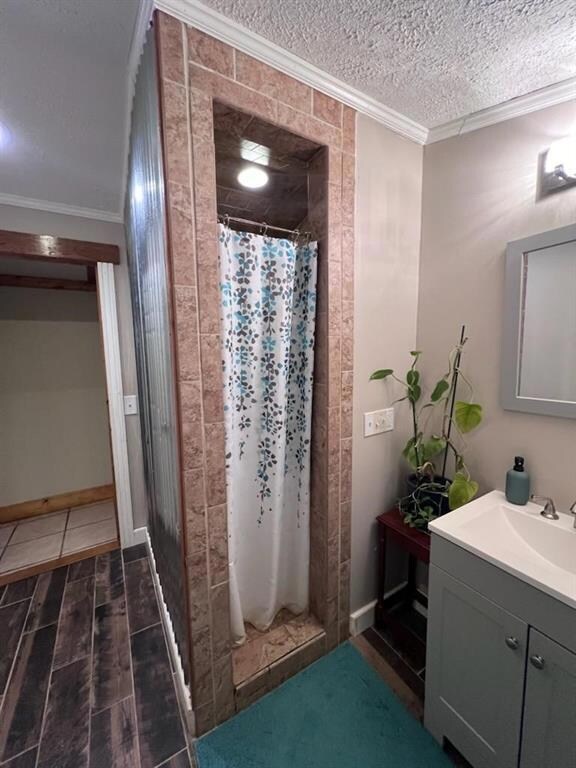Bathroom featuring vanity, curtained shower, wood-