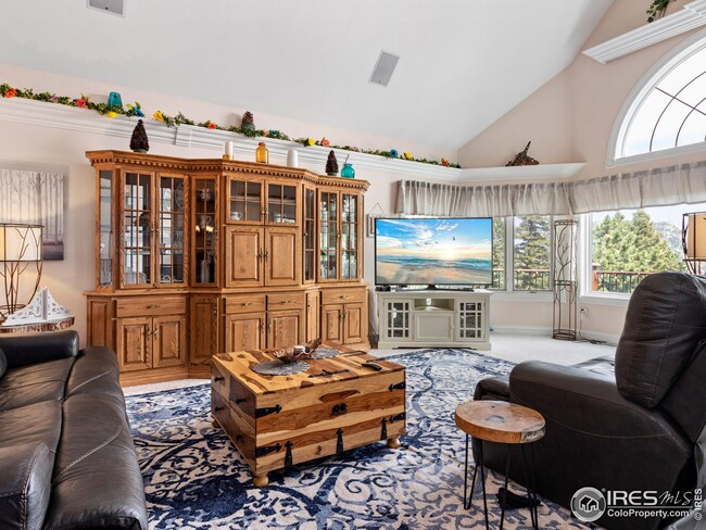 Great room has vaulted ceilings and large windows to enjoy the beautiful view, opens to a deck that runs the entire front side of the house