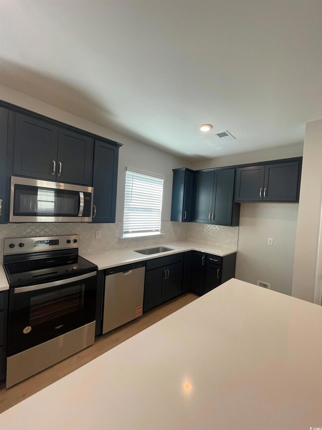 Kitchen with appliances with stainless steel finis