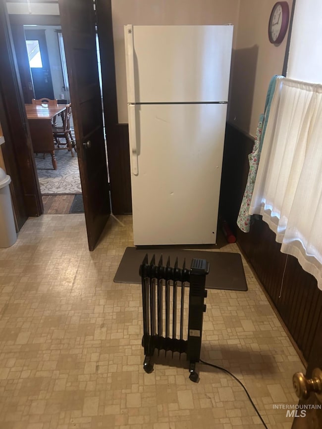 Kitchen with freestanding refrigerator