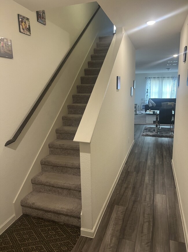 Stairs with wood finished floors and baseboards