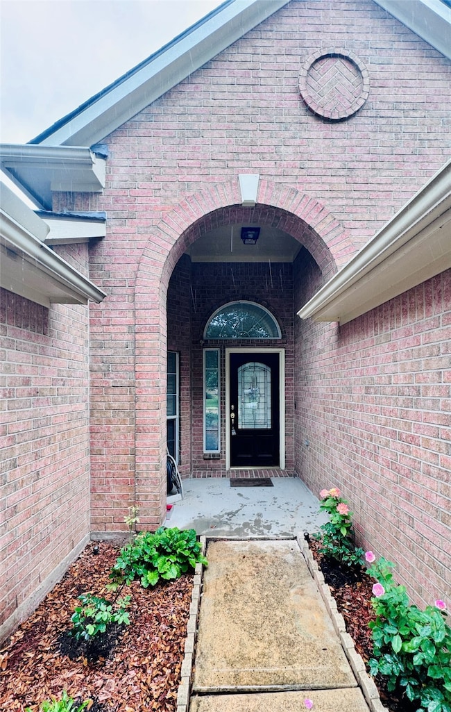 Welcoming brick entryway with a charming arched do
