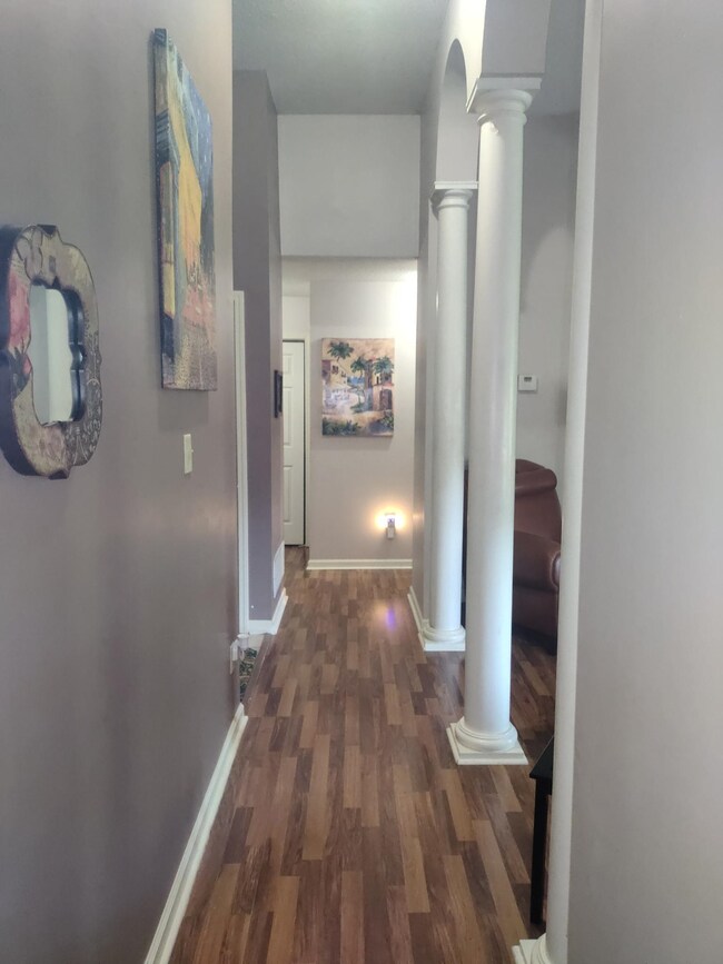 Hall with decorative columns and dark hardwood / w