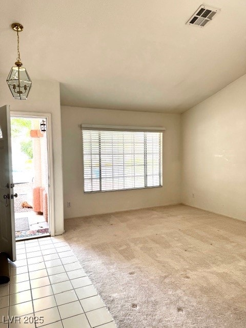 Entryway featuring light carpet and light tile pat