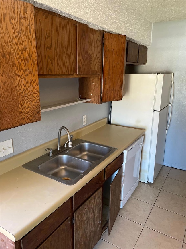 Kitchen with a sink, open shelves, white applianc