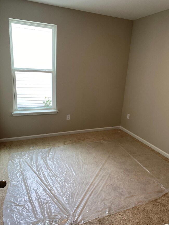 Empty room with carpet flooring