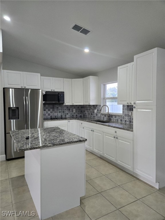 Kitchen with stainless steel refrigerator with ice